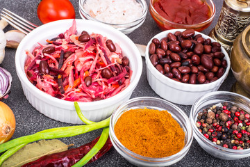 Salad of cabbage, carrots, beets and butter in a wooden bowl, re