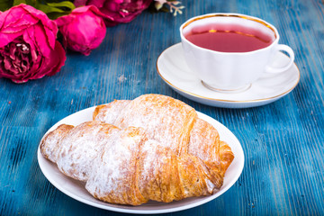 Croissant with kissel on blue background