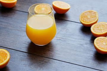 Orange juice in a glass on a wooden table.