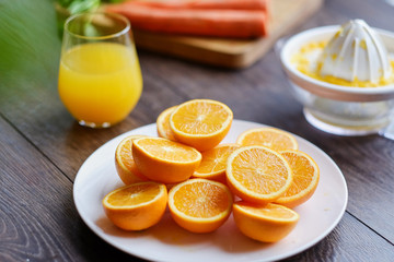 Orange juice in a glass and delicious carrot.