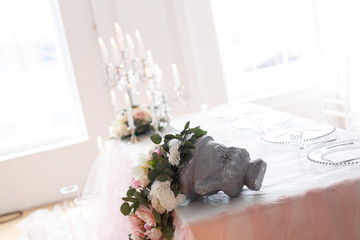 Candles near the wedding table in ivory colors