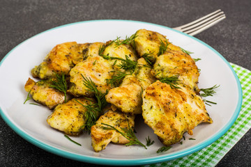 Pieces of fried chicken in breadcrumbs on plate