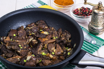 Fried wild mushrooms with onion in pan