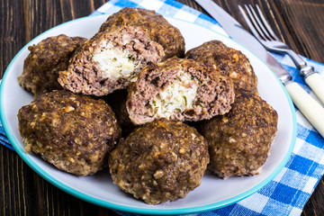 Meatballs stuffed with cheese and boiled egg