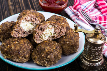 Meatballs stuffed with cheese and boiled egg