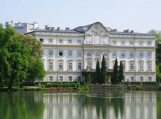 Fototapeta na wymiar Schloss Leopoldskron Palace with the Hohensalzburg Fortress in background, Salzburg, Austria