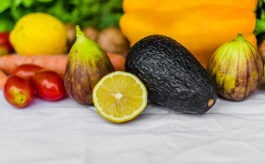 Close up photo of fresh fruit and vegetables, grains, and nuts on a white background. Concept of cooking and eating healthy food, fitness, vegetarian and vegan, and lifestyle.
