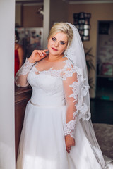 young bride portrait with perfume is getting ready at home in the morning, wedding day