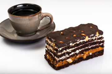 Chocolate caramel cake with nuts and whipped cream on white back
