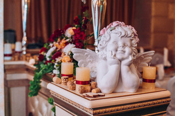 Wedding flower composition for guests and newlyweds tables. Wedding arch and flowers decor.