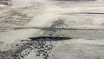 Fototapeta na wymiar pothole on the road after winter.