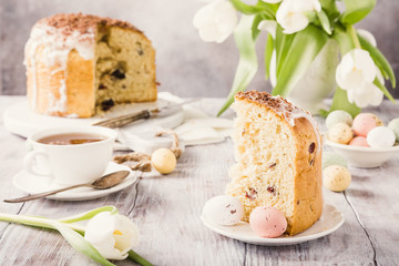 Slice of easter orthodox sweet bread, kulich end quail eggs. Holidays breakfast. Retro style toned.
