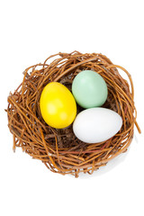 Three Easter egggs in a bird nest isolated