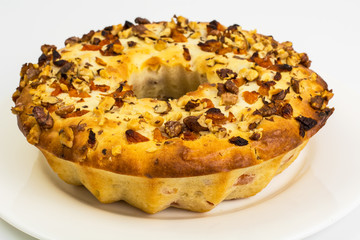 Curd cake with nuts and dried apricots on white background