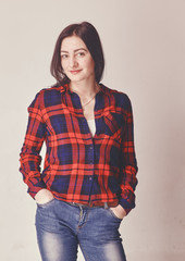 Woman dressed in checked long sleeve shirt