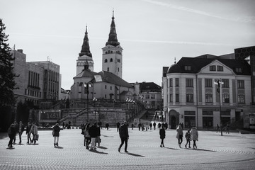 Naklejka premium City Zilina crowded by walking people with shadows. Slovakia