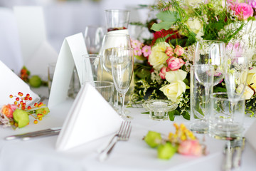 Beautiful table setting with crockery and flowers for a party, wedding reception or other festive event