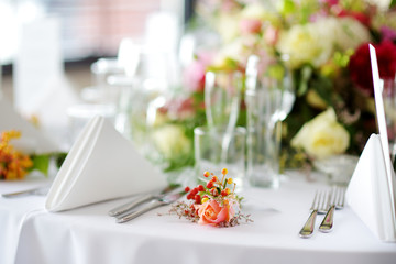 Beautiful table setting with crockery and flowers for a party, wedding reception or other festive event