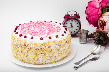 Sponge cake with almonds, whipped cream and berries