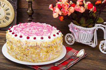 Sponge cake with almonds, whipped cream and berries