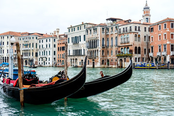 Fototapeta na wymiar Docked gondolas on the Grand Canal, in Venice, Italy