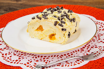 Sponge roll with whipped cream and fruit