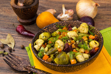Vegetable stew with mushrooms in wooden bowl