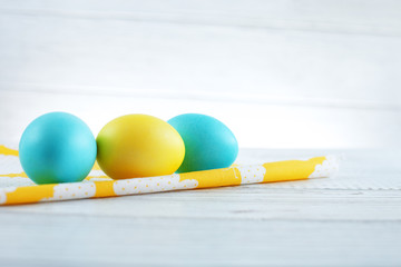 Blue and yellow eggs on the fabric. The concept of a happy Easter.