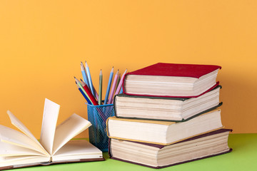 Open book, hardback bookson bright colorful background.