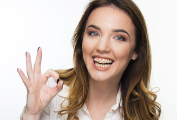 girl with brace smiling on white