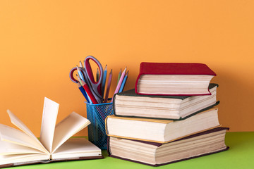 Open book, hardback bookson bright colorful background.