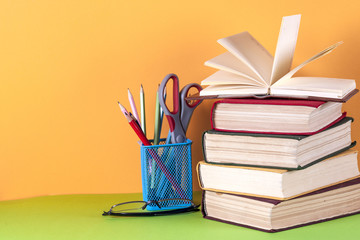 Open book, hardback bookson bright colorful background.
