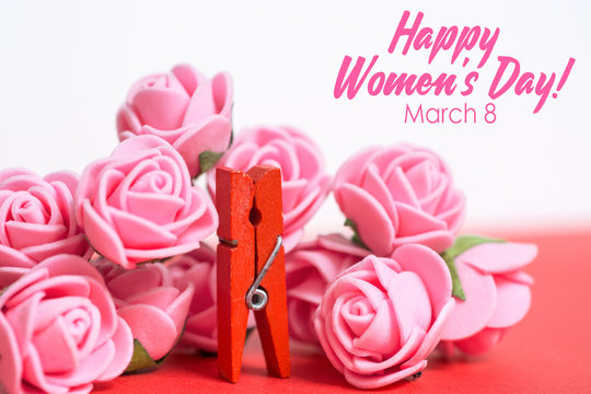 Happy Women’s Day - colorful wooden clothespin - abstract vision of men with bouquet of pink roses and woman.  