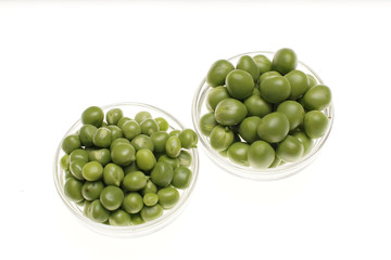 Fresh raw green peas on white background