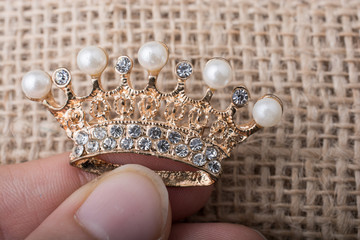 Golden color crown model with fake pearls