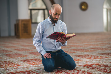 Muslim scholar studying holy and revered book Koran