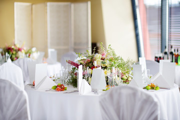 Beautiful table setting with crockery and flowers for a party, wedding reception or other festive event