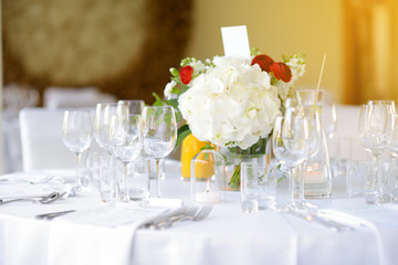 Beautiful table setting with crockery and flowers for a party, wedding reception or other festive event