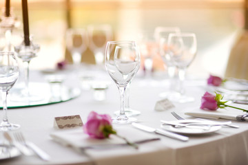 Beautiful table setting with crockery and flowers for a party, wedding reception or other festive...