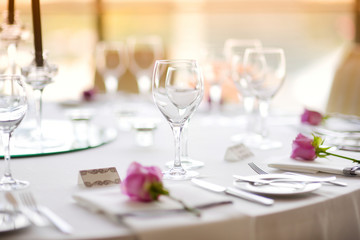 Beautiful table setting with crockery and flowers for a party, wedding reception or other festive event