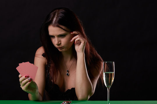 pretty young woman gambling on green table