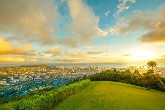 Tantalus Lookout at sunset, Puu Ualakaa State Park Honolulu. Tourists on panoramic city,Waikiki Beach and Diamond Head. Waikiki skyline Oahu Hawaii, United States. Vacation and travel concept.
