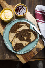 Pumpernickel and rye swirl bread Slices on blue palte and cutting board