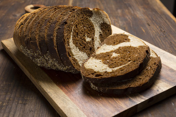 Pumpernickel and rye swirl bread Slices on cutting board