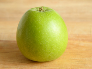 Green apple on wooden.