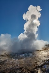 Fototapeta na wymiar Erupting geyser in sunlight