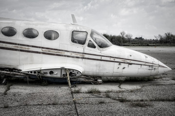 Old airplane with no wings in black and white