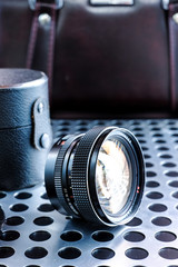Vintage manual photographic camera lens on metalic background