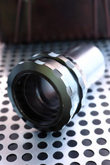 Projector lens on metalic background