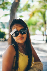 Happy portrait of Asian woman with sunglasses in summertime on the beach